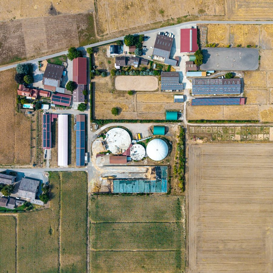 Aerial view of a large livestock farm with barns, silos and feed storage